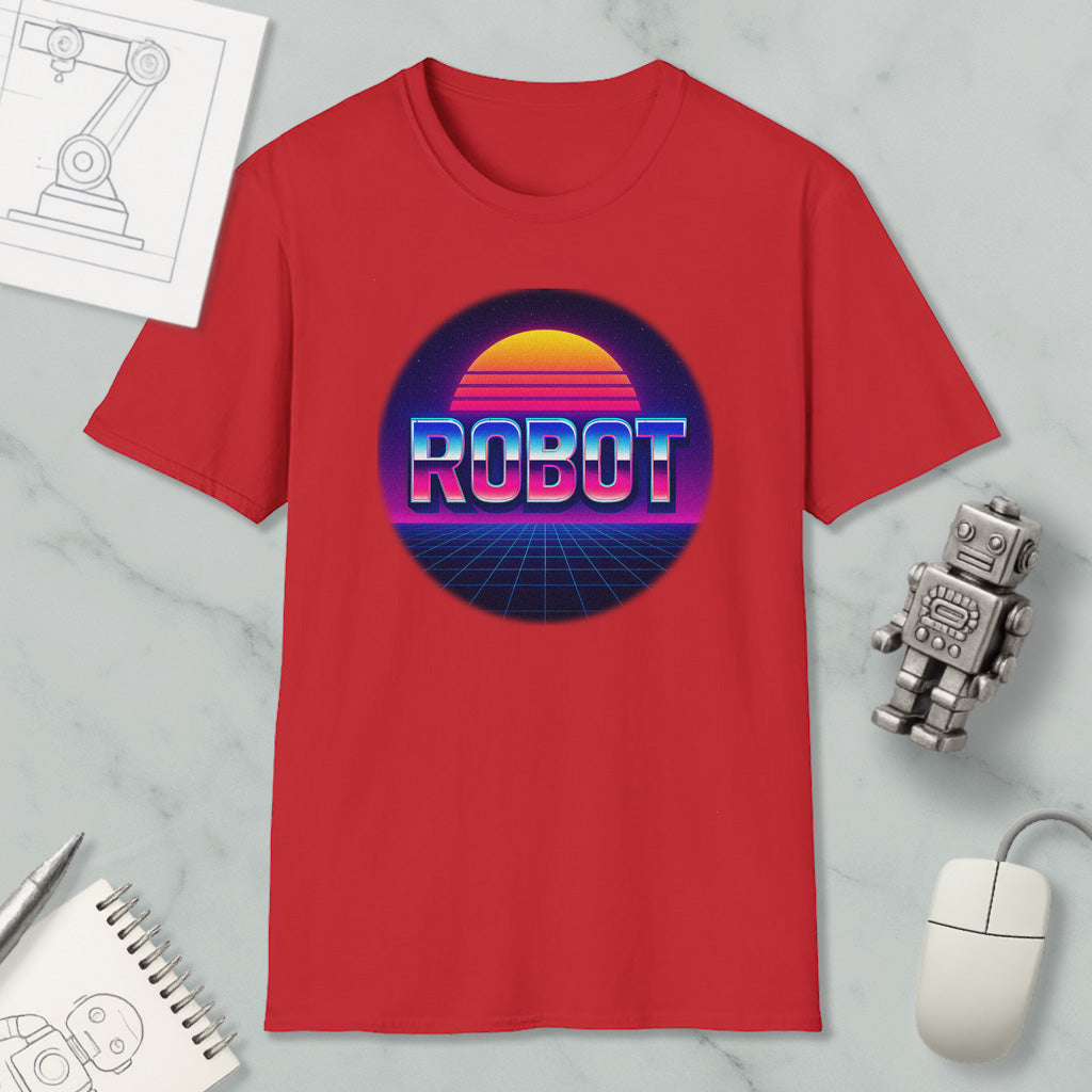 a red t-shirt with a graphic design of a robot and a sunset, along with various objects such as a computer mouse, a notebook, and a pen.