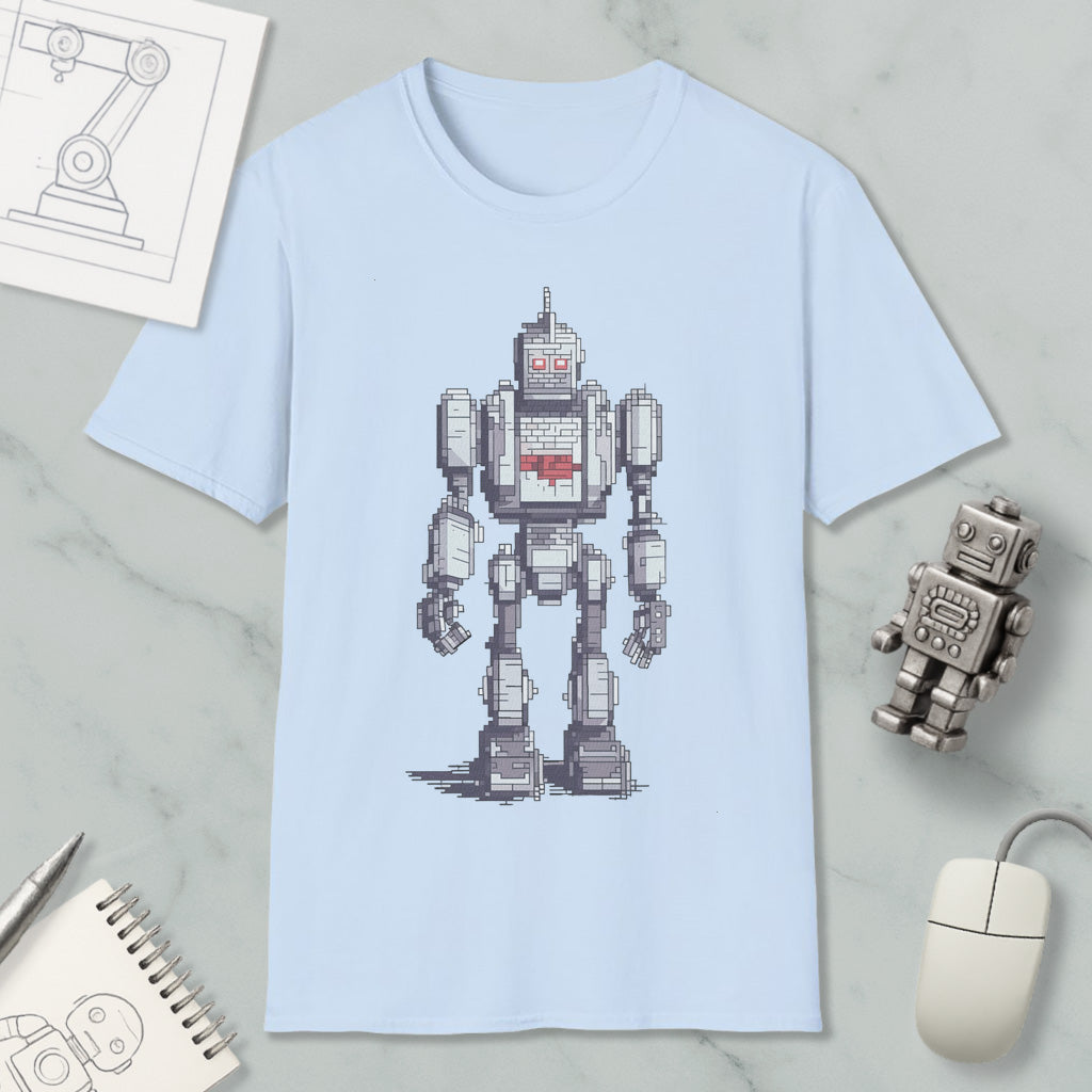 a light blue t-shirt with a pixelated robot design, along with various objects such as a computer mouse, a notebook, and a pen.