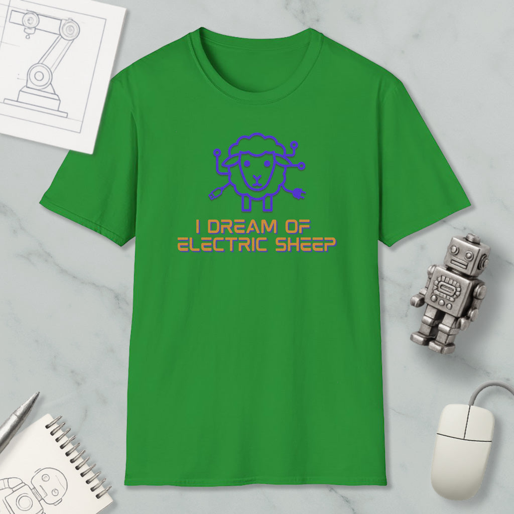 a green t-shirt with a cartoon sheep design and text, along with a computer mouse, a notebook, and a robot figurine.
