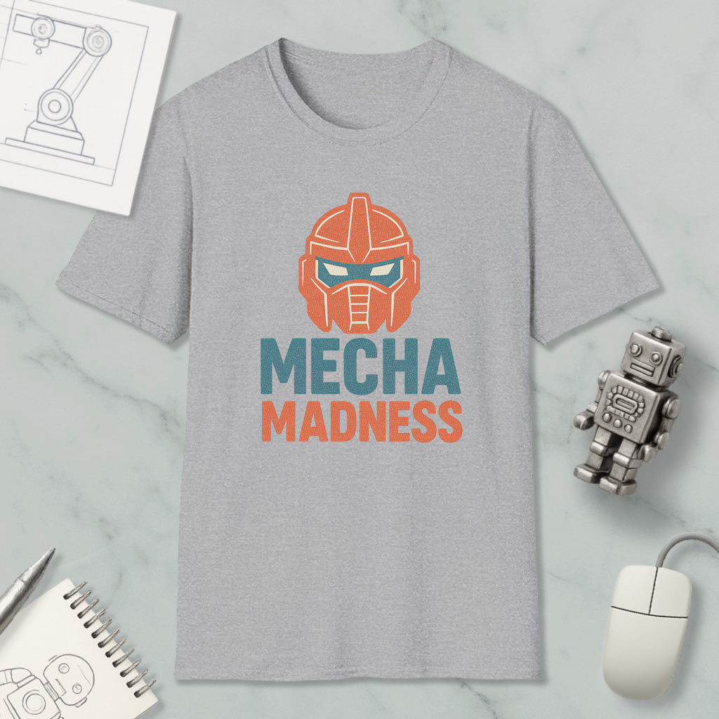 a gray t-shirt with a graphic design of a robot's head and the text "MECHA MADNESS" printed on it, along with a computer mouse and a notebook.