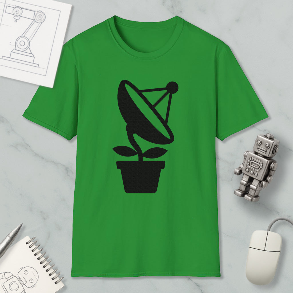 a green t-shirt with a black satellite dish graphic, along with a small robot and a computer mouse, all placed on a marble surface.