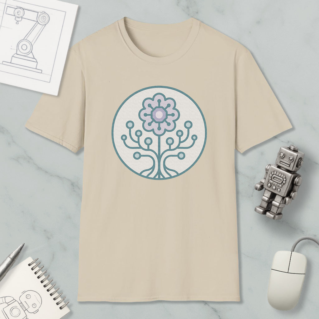 a beige t-shirt with a circular design on it, surrounded by various objects such as a computer mouse, a robot, and a notebook.