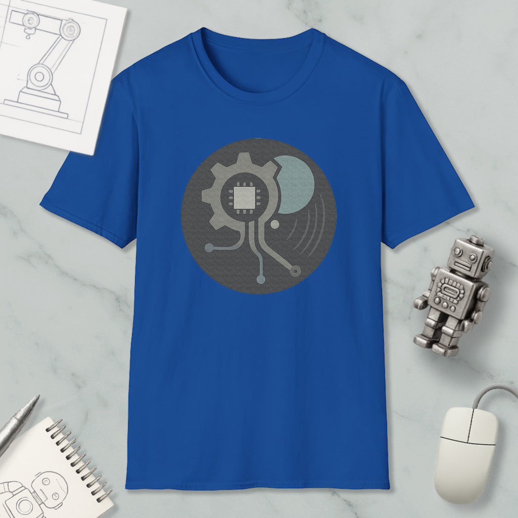 a blue t-shirt with a graphic design, a computer mouse, a notebook, and a small robot figurine on a marble surface.