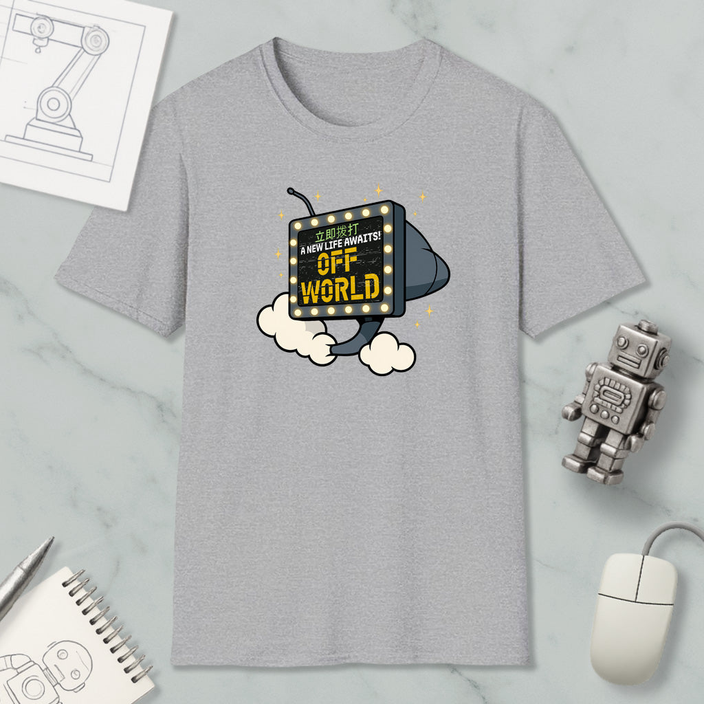 a gray t-shirt with a graphic design, a computer mouse, a robot, and some other items on a marble surface.