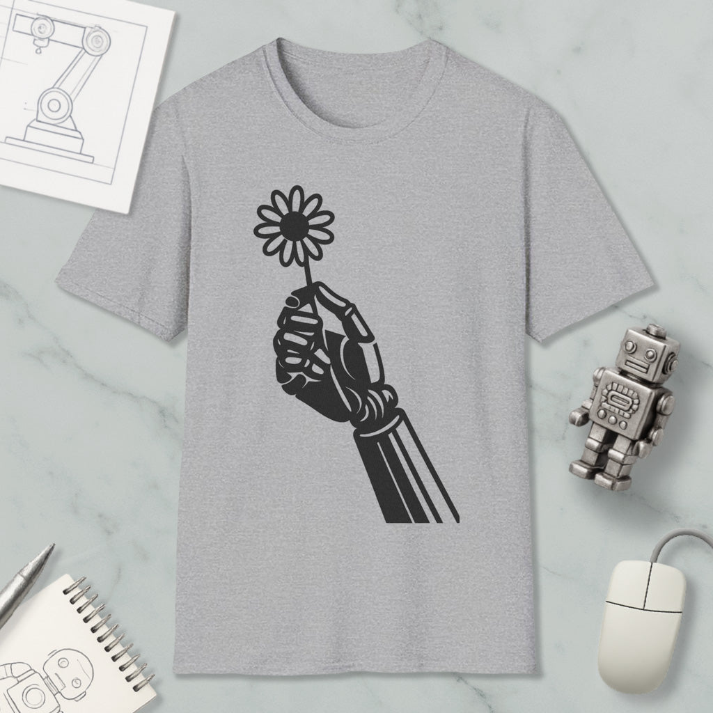 a gray t-shirt with a black graphic design of a hand holding a flower, along with various objects such as a computer mouse, a robot, and a notebook.