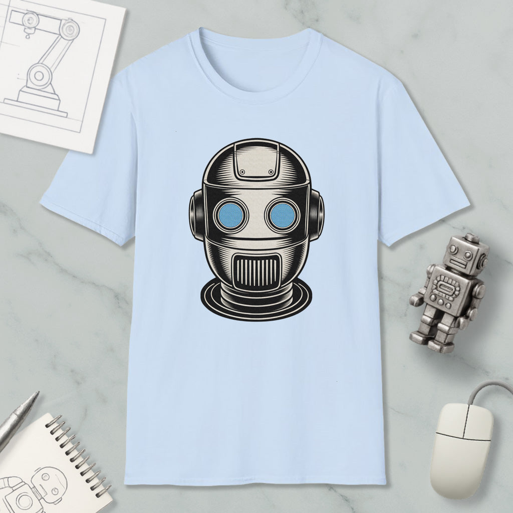 a light blue t-shirt with a graphic of a robot or robot head, along with a small robot and a computer mouse on a marble surface.