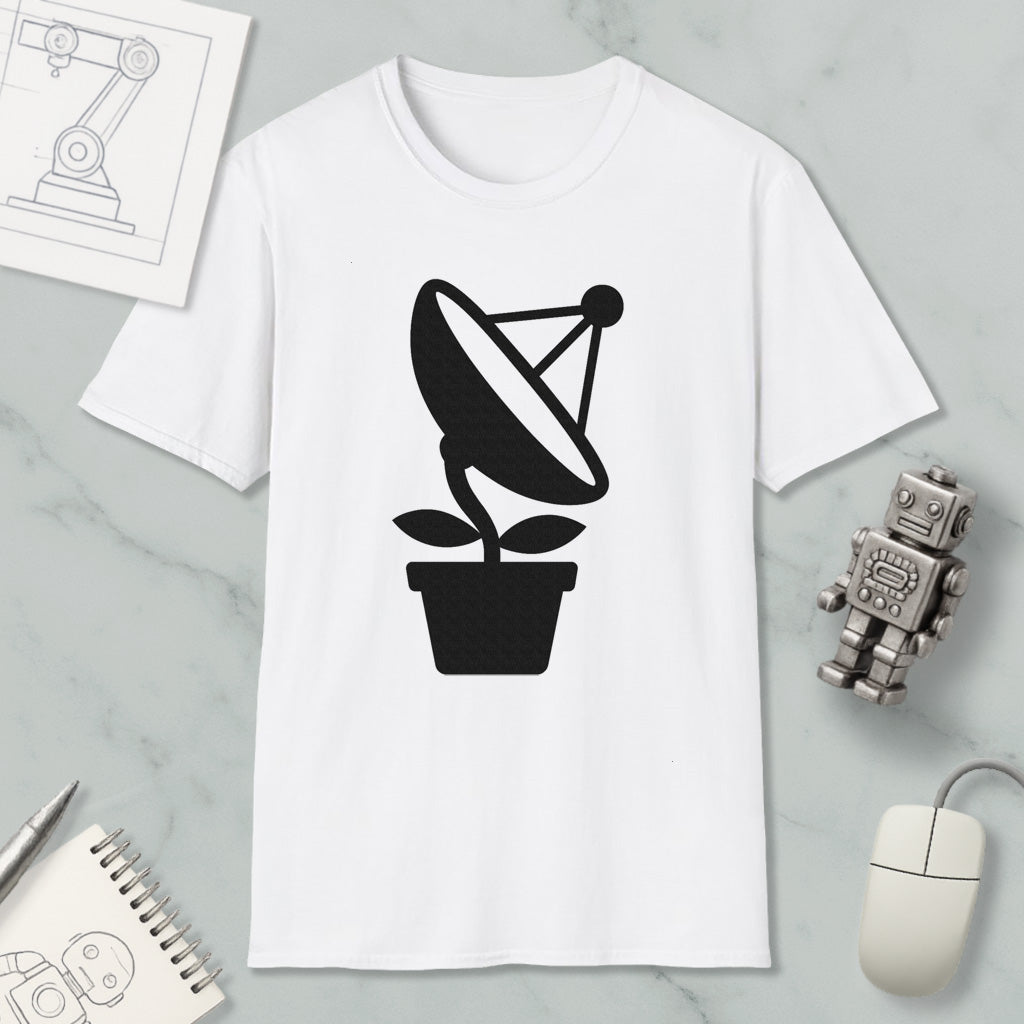 a white t-shirt with a black graphic design of a satellite dish on a plant, along with a computer mouse, a notebook, and a robot figurine.