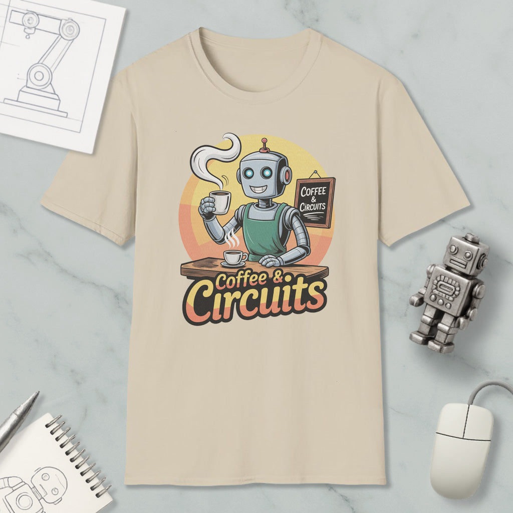 a t-shirt with a cartoon robot holding a cup of coffee and a sign that says "Coffee & Circuits". The t-shirt is placed on a marble surface, along with a computer mouse, a notebook, and a small robot figurine.