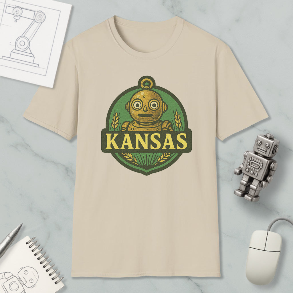 a beige t-shirt with a graphic design of a robot and the word "KANSAS" printed on it, along with a small robot and a computer mouse.