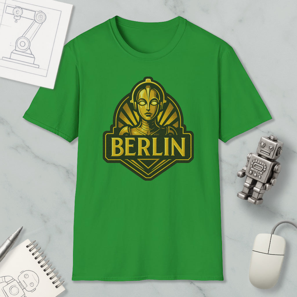 a green t-shirt with a graphic design of a robot or character, along with a computer mouse and other office supplies.