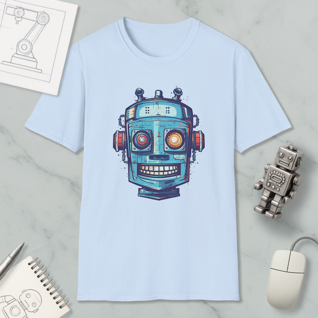 a light blue t-shirt with a colorful robot graphic printed on it, along with various objects such as a computer mouse, a notebook, and a pen.