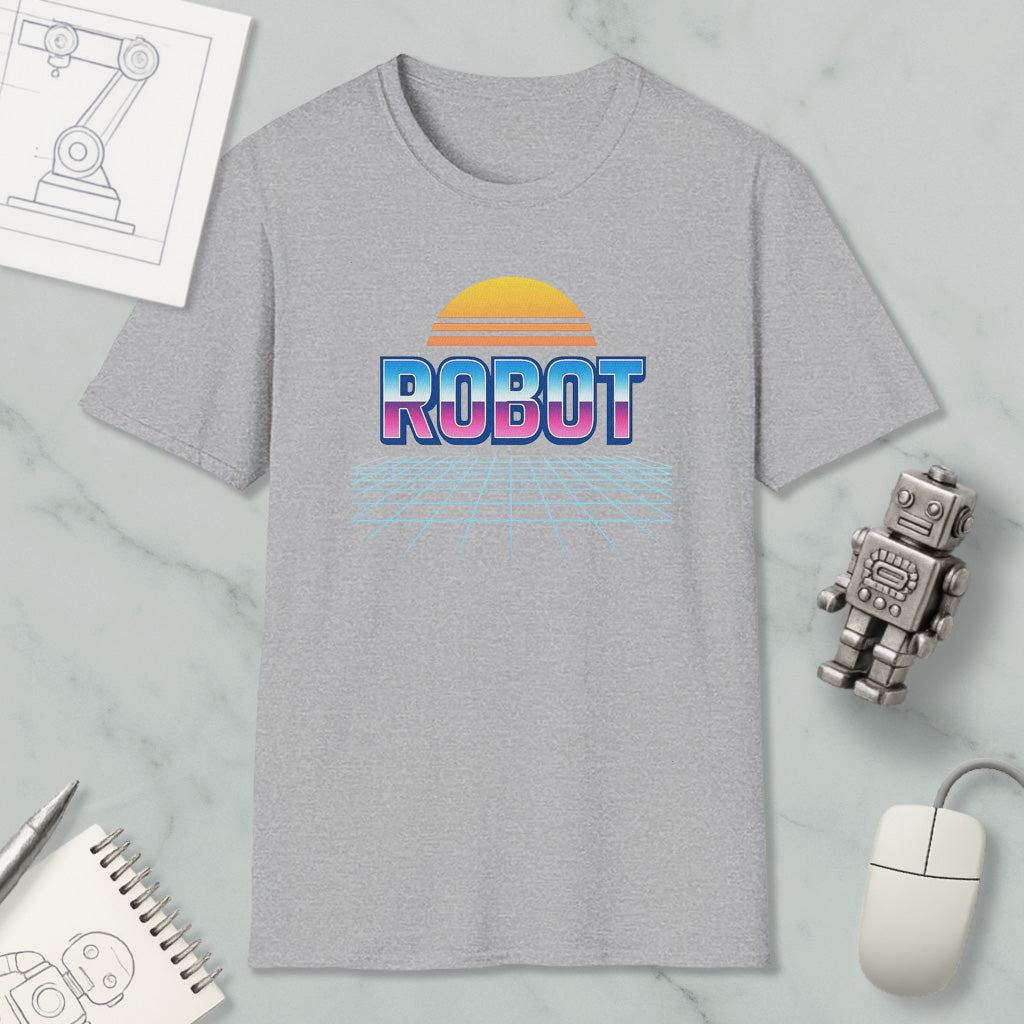a gray t-shirt with a graphic design of a robot and a sunset, along with various objects such as a computer mouse, a notebook, and a pen.