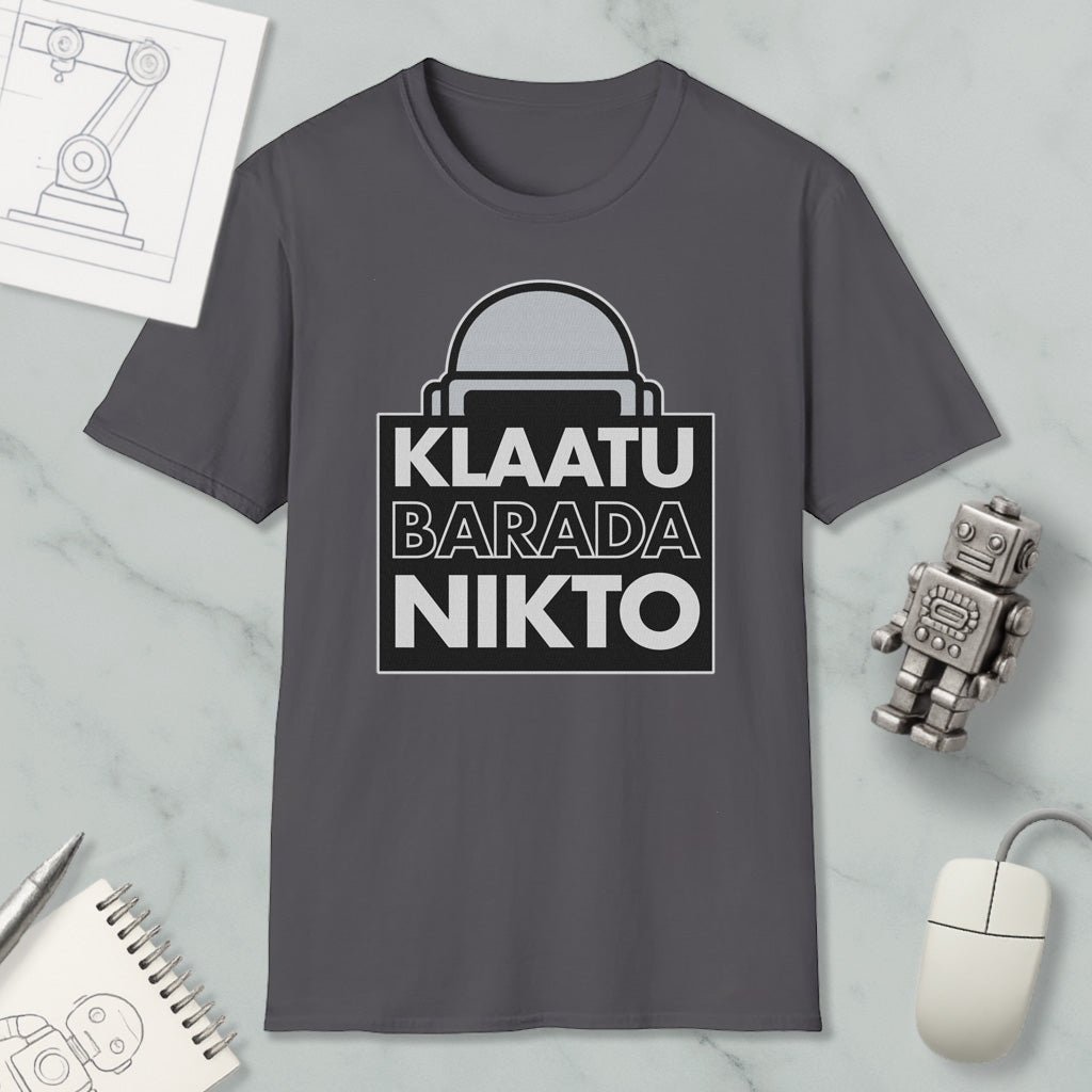 a gray t-shirt with a graphic design, a computer mouse, a notebook, and a small robot on a marble surface.