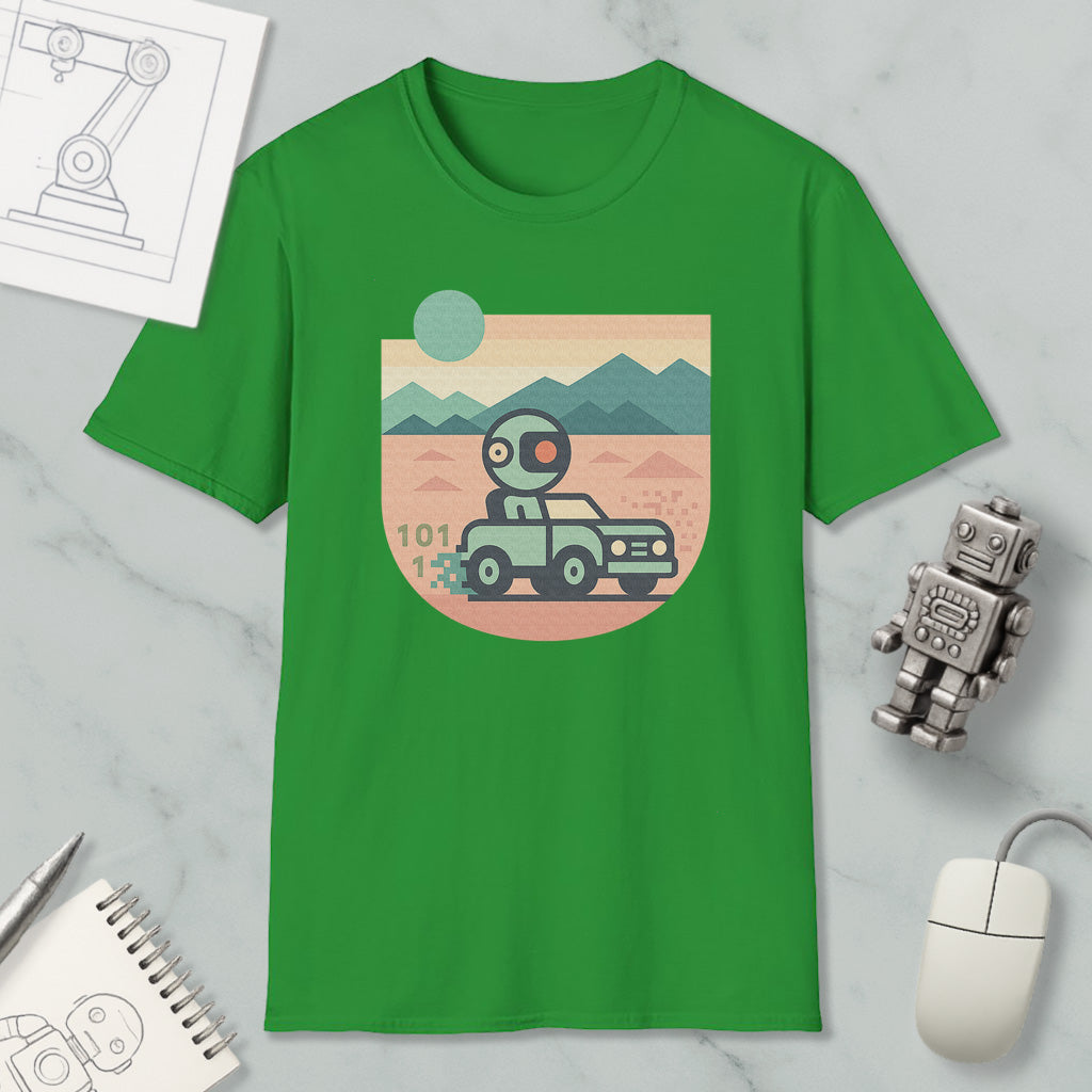a green t-shirt with a graphic design depicting a robot driving a car on a desert road, surrounded by mountains. The t-shirt is placed on a marble surface, with a computer mouse, a notebook, and a small robot figurine nearby.
