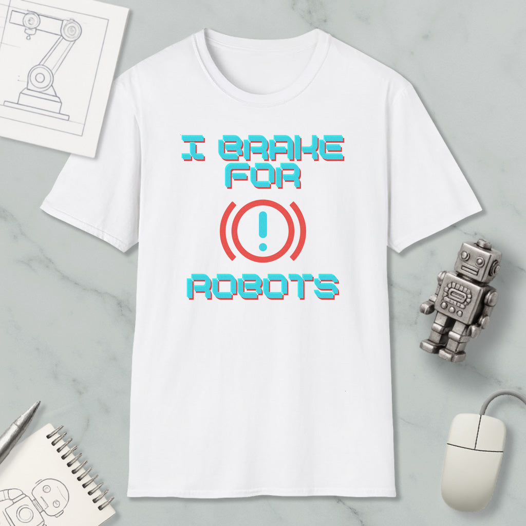 a white t-shirt with a humorous text printed on it, along with a small robot toy and some other items such as a notebook and a mouse.