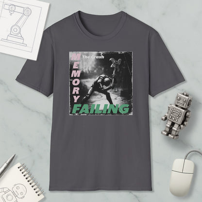 a gray t-shirt with a graphic design depicting a person in a dark environment, surrounded by various objects such as a robot, a mouse, and a notebook.