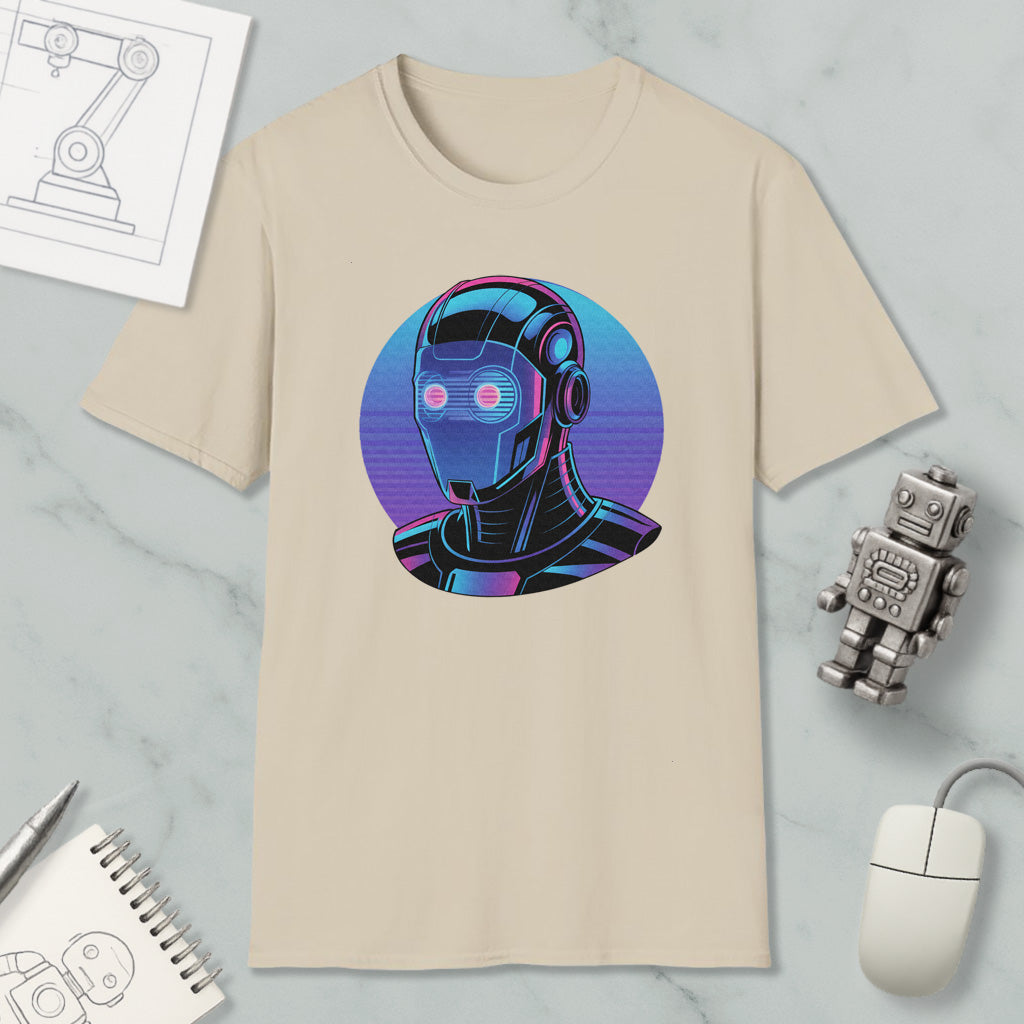 a beige t-shirt with a graphic design of a robot or cyborg head, surrounded by various objects such as a computer mouse, a notebook, and a pen.