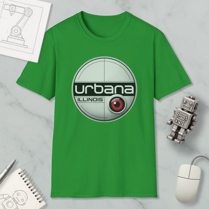 a green t-shirt with a circular logo, a computer mouse, a notebook, and a small robot on a marble surface.