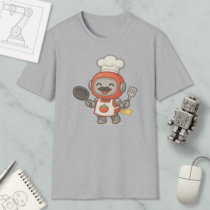 a gray t-shirt with a cartoon robot chef wearing a chef's hat and holding a frying pan and spatula. The t-shirt is displayed on a marble surface, along with a computer mouse, a pen, and a notebook.