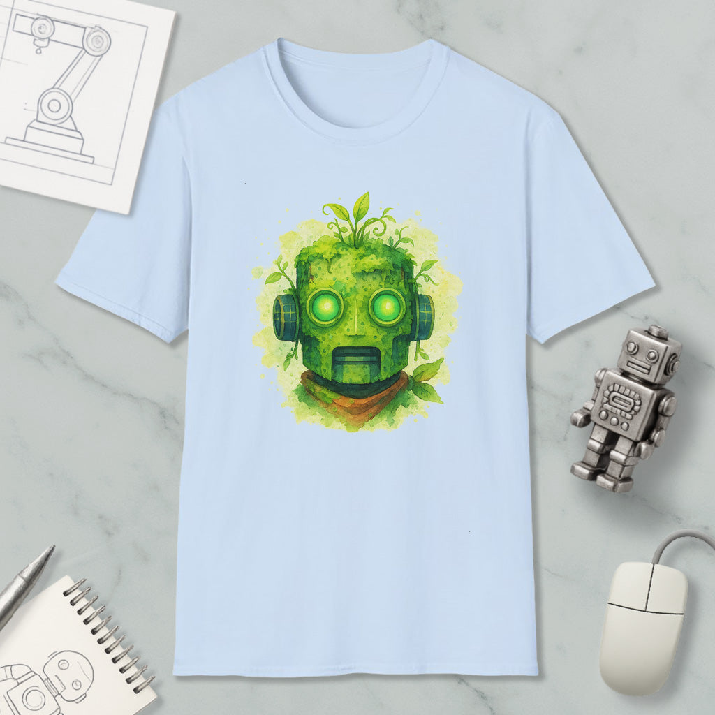 a light blue t-shirt with a green robot-like face design, surrounded by various objects such as a computer mouse, a notebook, and a small robot figurine.