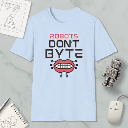a light blue t-shirt with a graphic design that says "ROBOTS DON'T BYTE" and includes a robot mouth with teeth. The t-shirt is placed on a marble surface, surrounded by various objects such as a computer mouse, a notebook, and a pen.