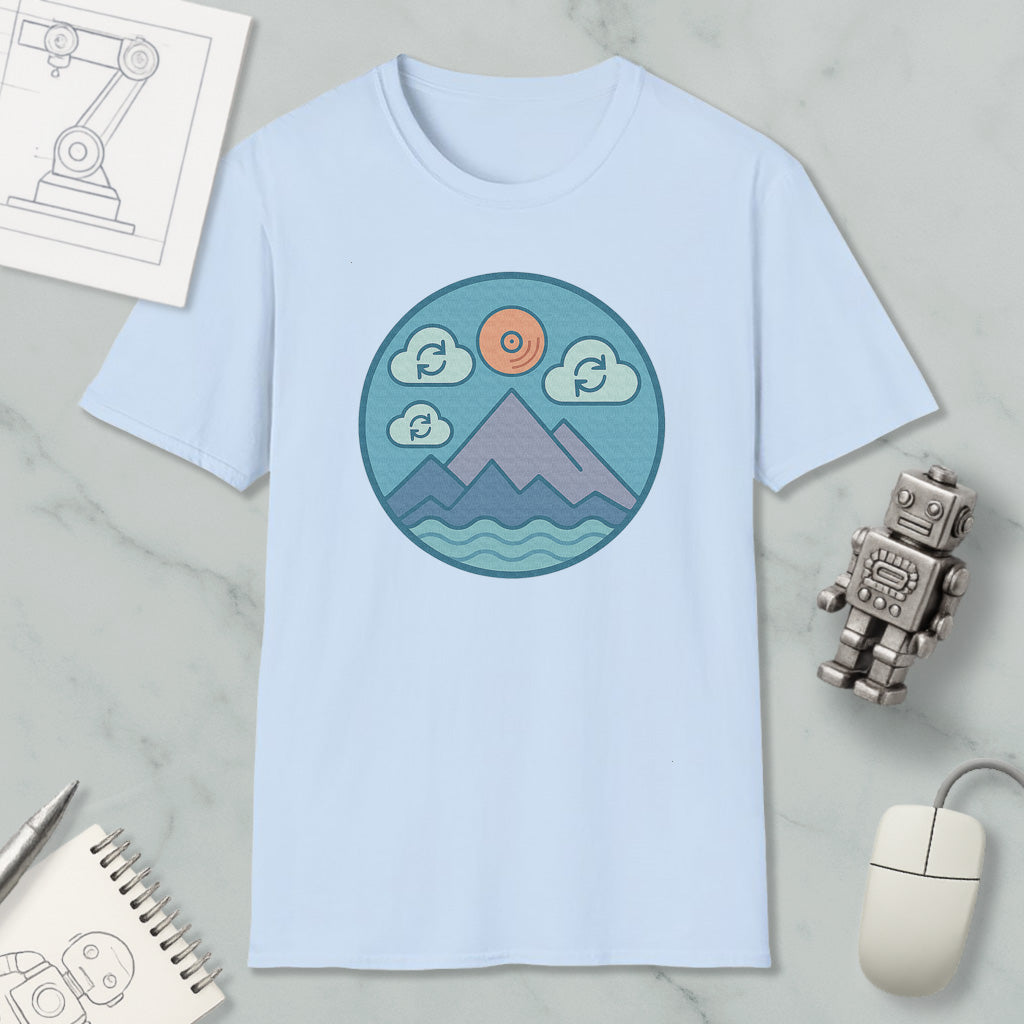 a light blue t-shirt with a circular graphic design depicting mountains, clouds, and a sun, along with a robot and a computer mouse.