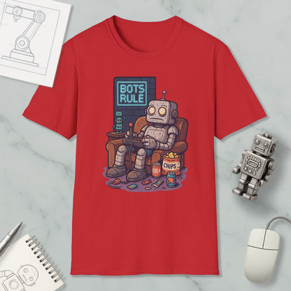 a red t-shirt with a cartoon robot sitting in a chair and playing a video game, surrounded by various objects such as a computer mouse, a notebook, and a robot figurine.