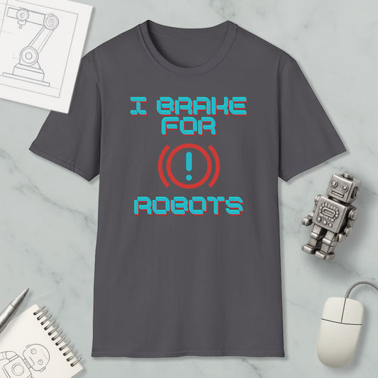 a gray t-shirt with a humorous text design, a small robot, a computer mouse, and some other items on a marble surface.