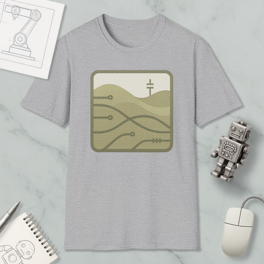 a gray t-shirt with a graphic design, a small robot, a computer mouse, and some sketches or drawings on a marble surface.