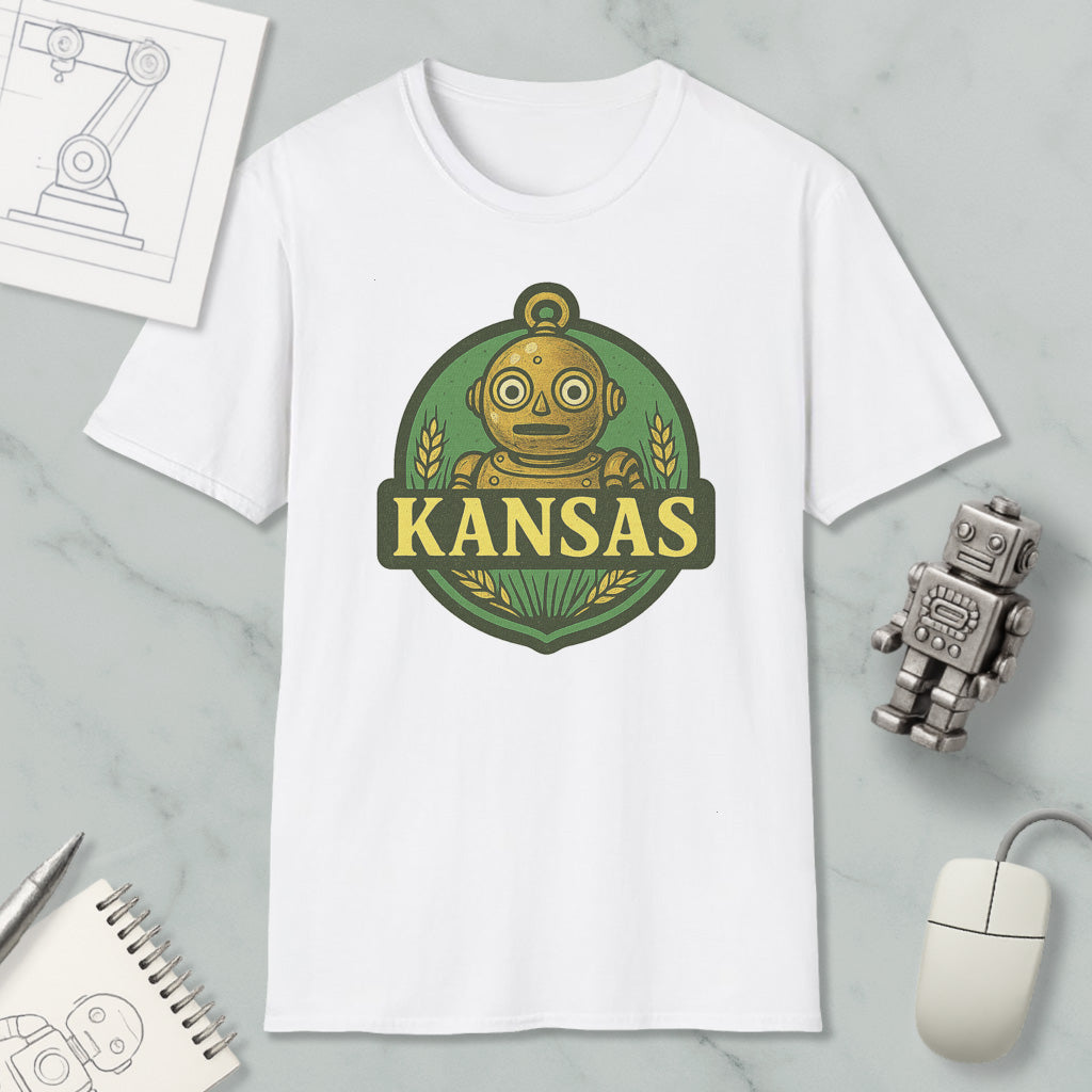 a white t-shirt with a graphic design of a robot and the word "KANSAS" printed on it, along with a small robot figurine and a computer mouse.