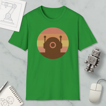 a green t-shirt with a circular graphic design, a small robot, a computer mouse, and a notebook on a marble surface.