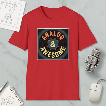 a red t-shirt with a graphic design that says "ANALOG & AWESOME" on it, along with a computer mouse and a robot figurine.