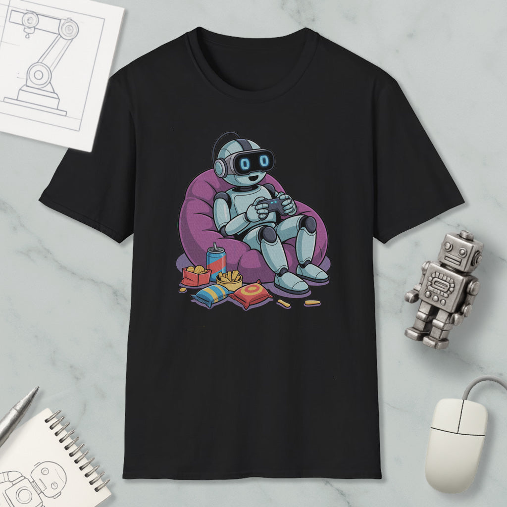 A black t-shirt with a graphic design depicting a robot sitting in a bean bag chair, holding a controller, surrounded by snacks and a toy robot.
