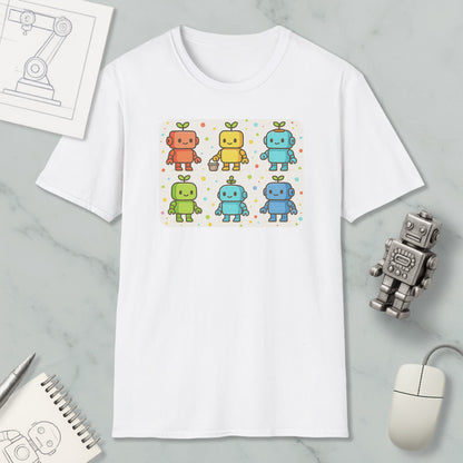 a white t-shirt with a colorful graphic of six cartoon robots, each with a unique color and design. The t-shirt is placed on a marble surface, surrounded by various objects such as a computer mouse, a notebook, and a pen.