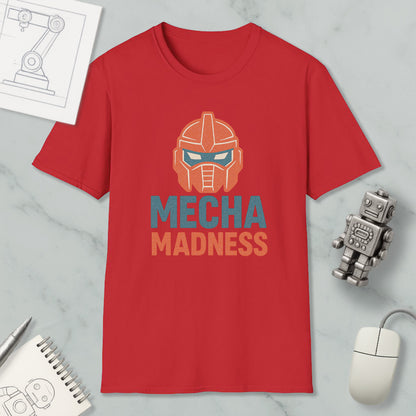 a red t-shirt with a graphic design of a robot's head and the text "MECHA MADNESS" printed on it, along with a computer mouse and a notebook.