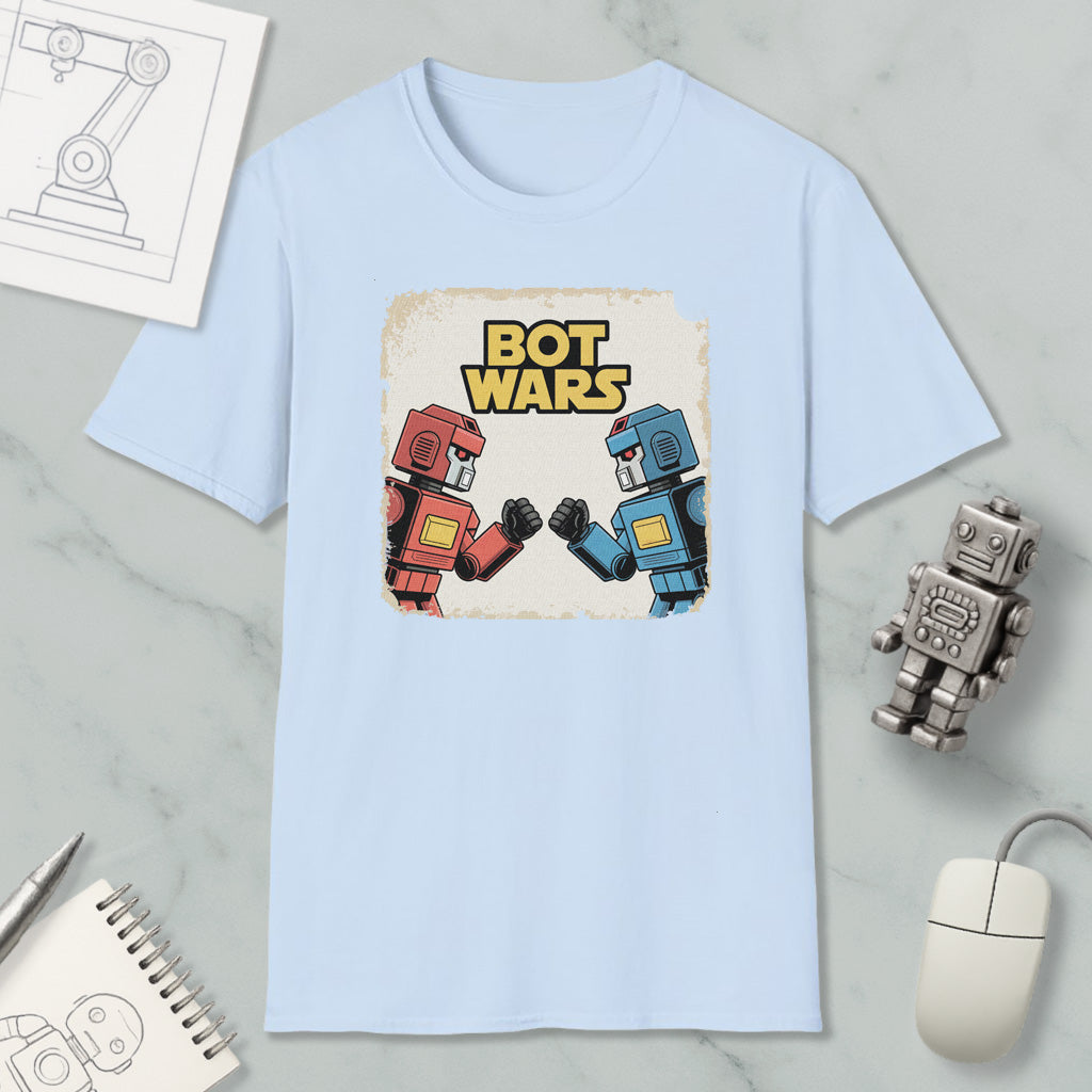 a light blue t-shirt with a graphic design of two robot characters, one in red and the other in blue, engaged in a battle or fight. The t-shirt is displayed on a marble surface, along with various objects such as a computer mouse, a pen, and a notebook.