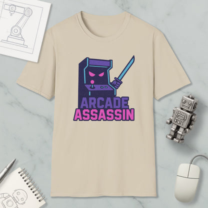 a beige t-shirt with a graphic design depicting a video game character holding a sword and the text "ARCADE ASSASSIN" in a stylized font.