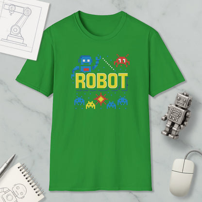a green t-shirt with a robot graphic and pixel art, along with a computer mouse, a notebook, and a small robot figurine.