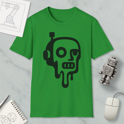 a green t-shirt with a black graphic design depicting a robot or robot-like figure with a dripping or melting appearance. The t-shirt is placed on a marble surface, along with a computer mouse, a notebook, and a small robot figurine.