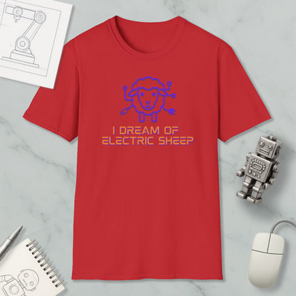 a red t-shirt with a blue sheep graphic and text, along with a computer mouse, a notebook, and a robot figurine, all placed on a marble surface.