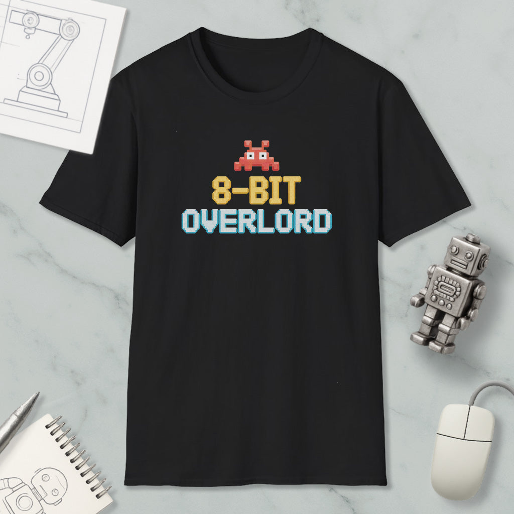 a black t-shirt with a pixelated character and text, along with various objects such as a mouse, a robot, and a notebook.