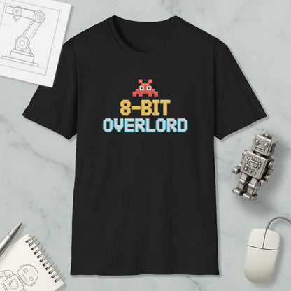 a black t-shirt with a pixelated character and text, along with various objects such as a mouse, a robot, and a notebook.