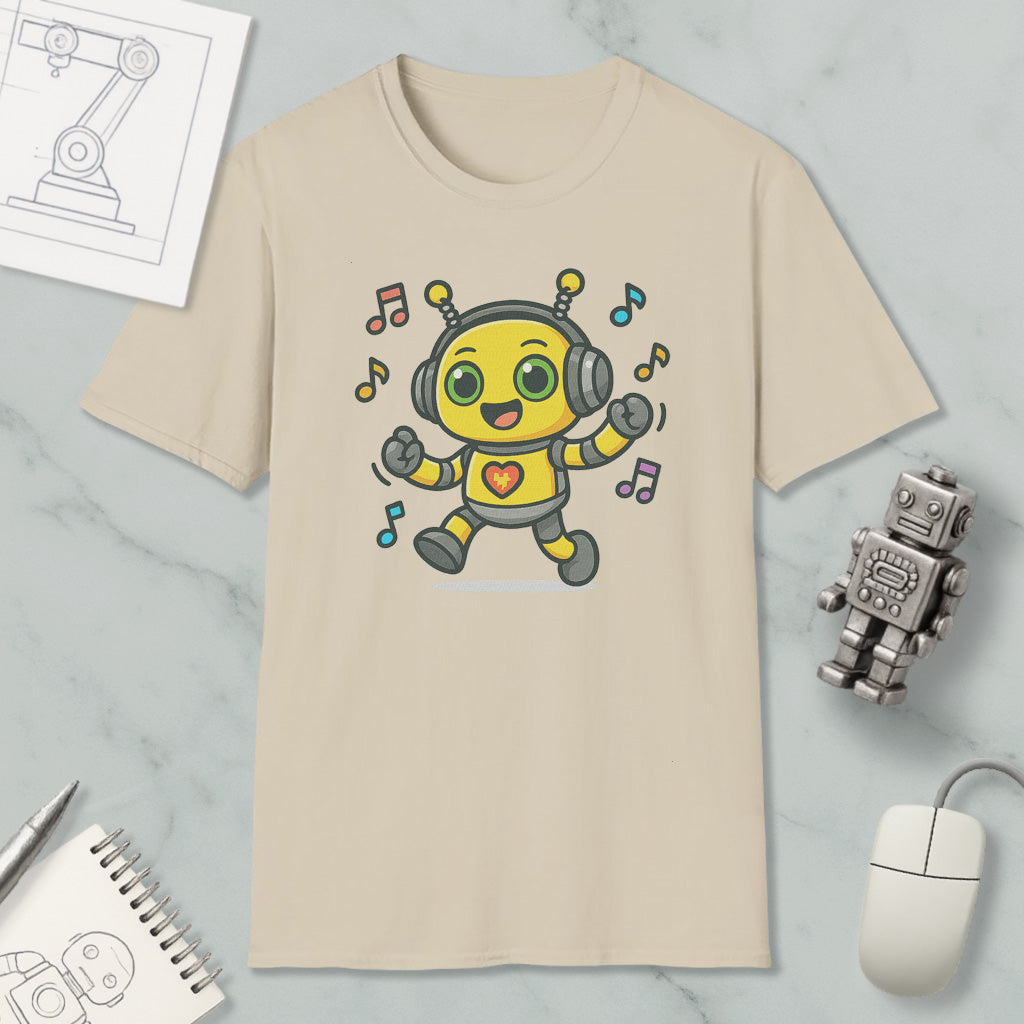 a beige t-shirt with a cartoon robot wearing headphones and dancing, surrounded by musical notes. The t-shirt is placed on a marble surface, along with a computer mouse, a pen, and a notebook.