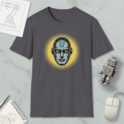 a gray t-shirt with a graphic design of a robot's face, surrounded by a yellow sunburst pattern. The t-shirt is placed on a marble surface, with a computer mouse, a notebook, and a small robot figurine nearby.