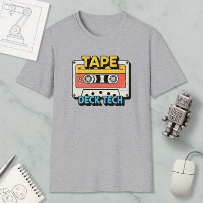 a gray t-shirt with a graphic design of a cassette tape and the text "TAPE Deck Tech" printed on it, along with a robot and a computer mouse.