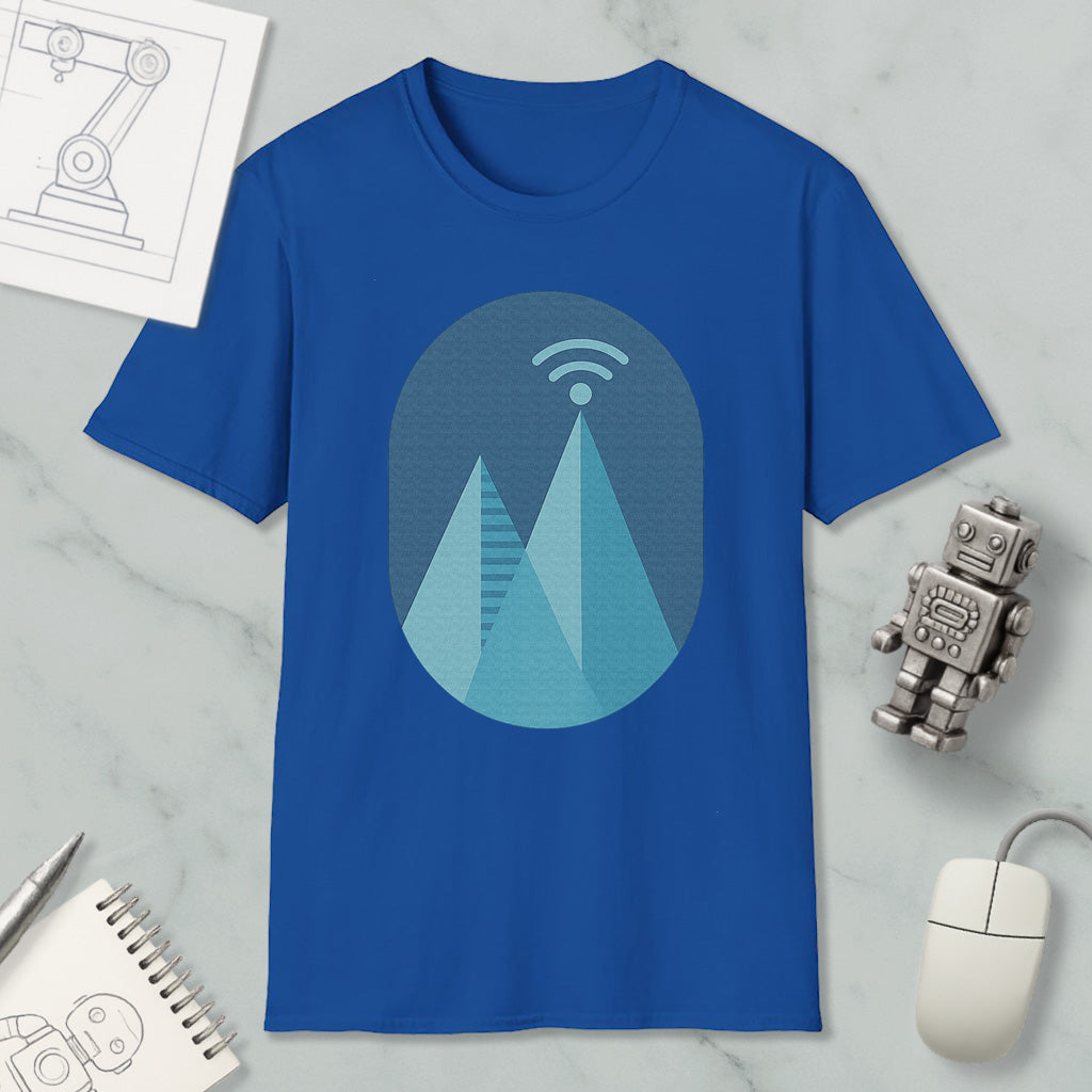 a blue t-shirt with a graphic design of a mountain range, a Wi-Fi symbol, and a robot figure, along with some other items such as a notebook, a mouse, and a pen.