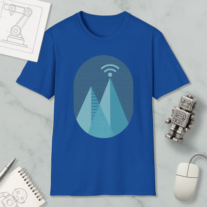 a blue t-shirt with a graphic design of a mountain range, a Wi-Fi symbol, and a robot figure, along with some other items such as a notebook, a mouse, and a pen.