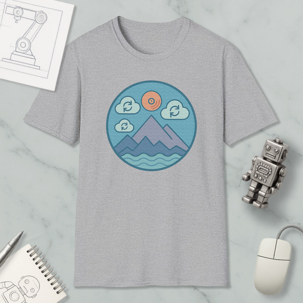 a gray t-shirt with a circular graphic design depicting mountains, clouds, and a sun, along with a robot and a computer mouse.