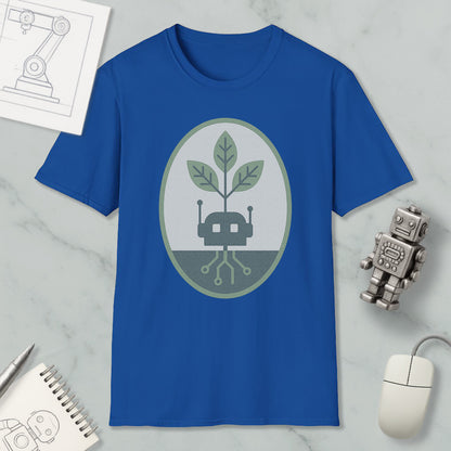 a blue t-shirt with a graphic design, a small robot, a computer mouse, and a notebook on a marble surface.