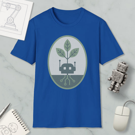 a blue t-shirt with a graphic design, a small robot, a computer mouse, and a notebook on a marble surface.